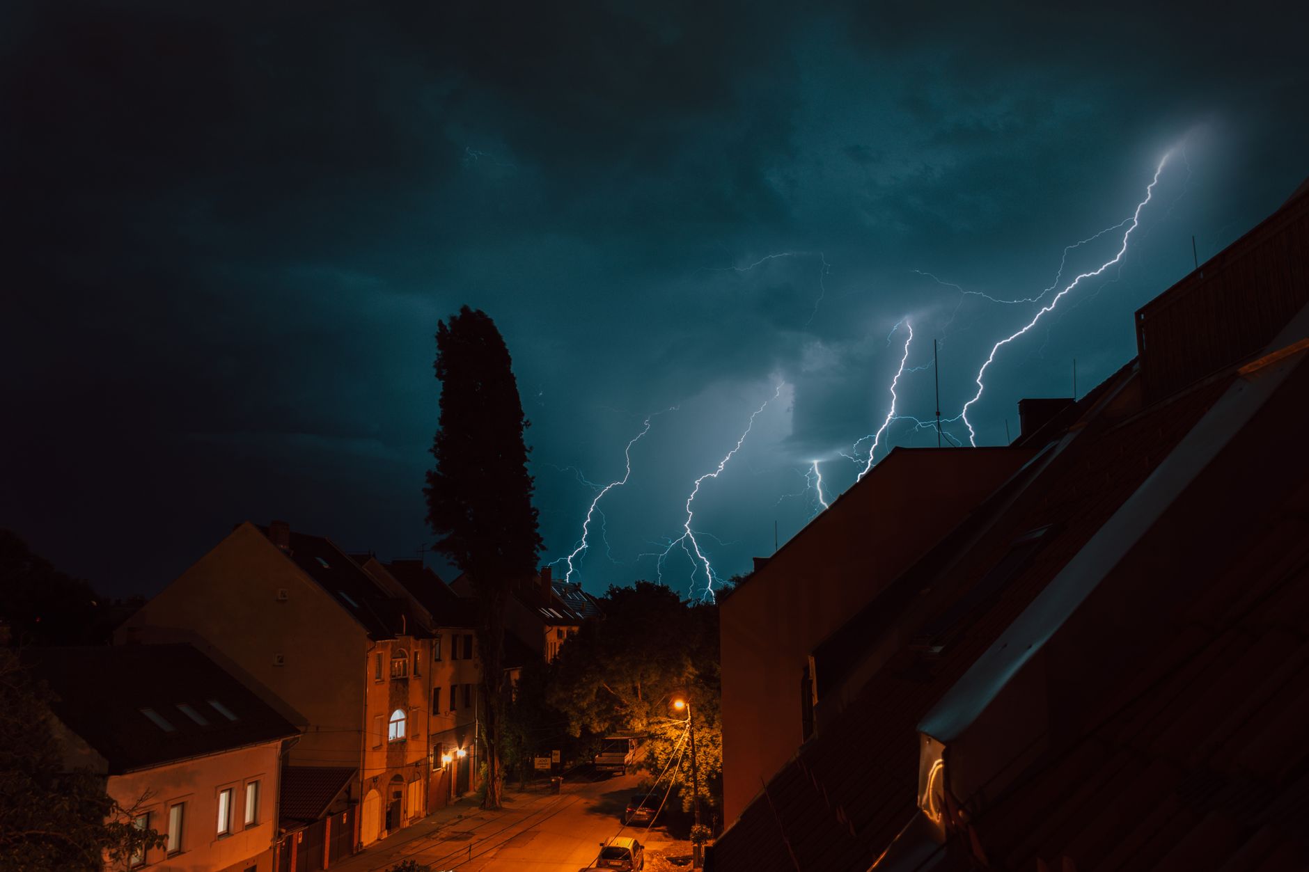 Heavy rain falling on a suburban home during a severe storm