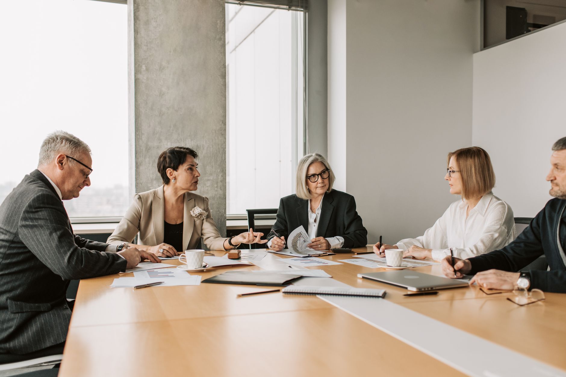 Business executives in a corporate meeting discussing company restructuring