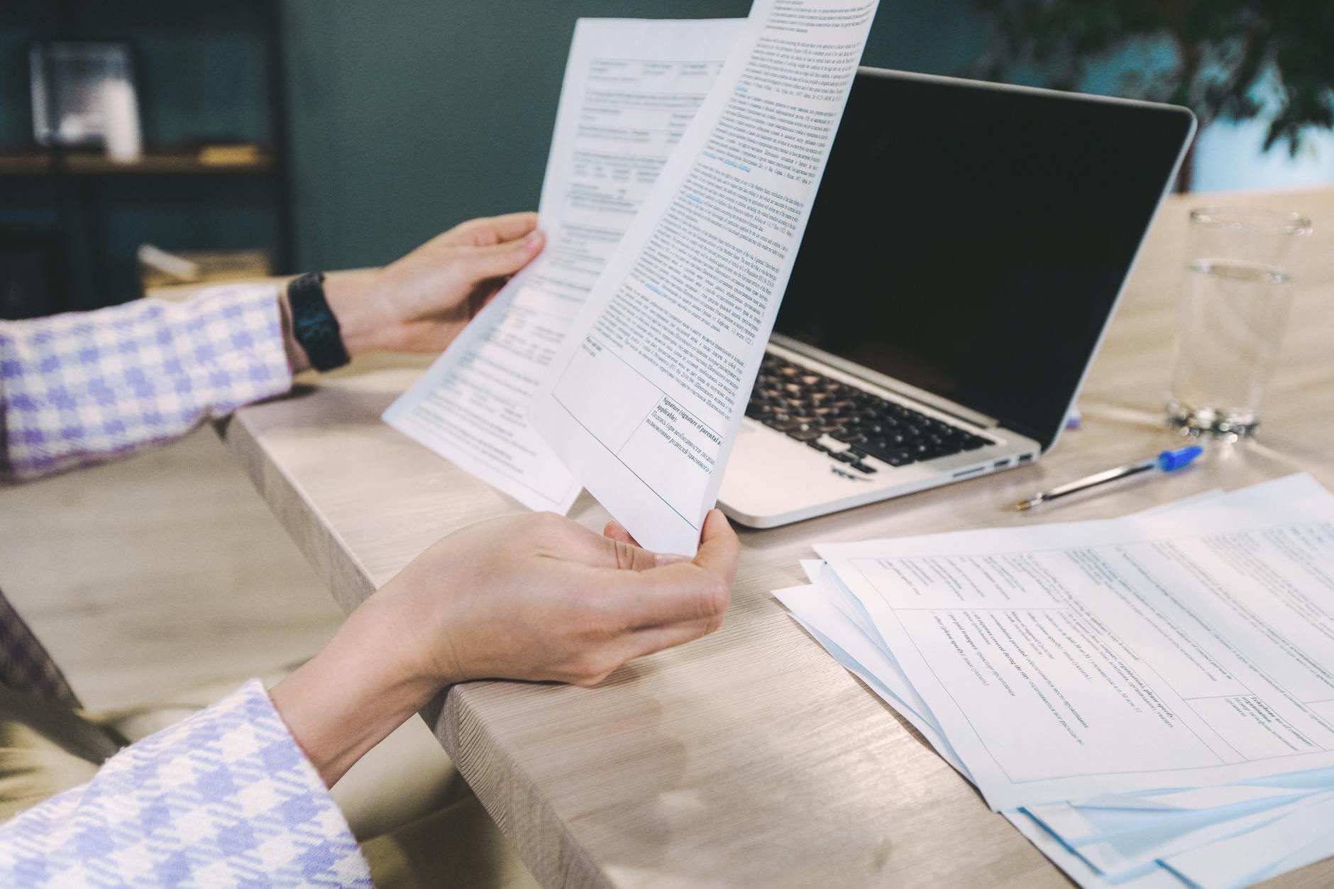 Person reviewing economic employment data report at a desk