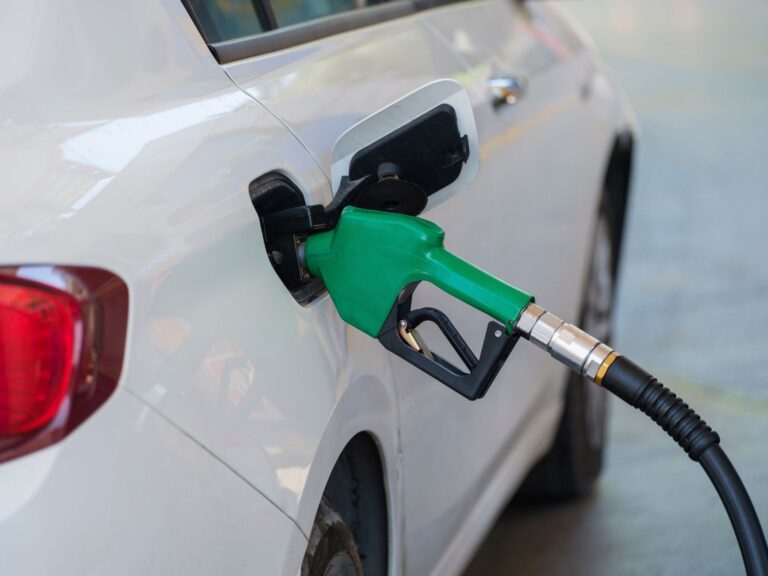 Gas Prices Snap Lower Streak as Oil Climbs Back Driver filling up at a gas station pump showing price per gallon