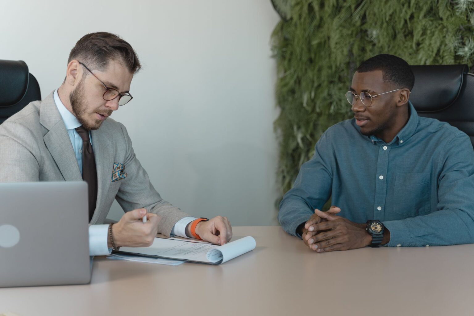 A recruiter interviewing a job candidate in a modern office setting