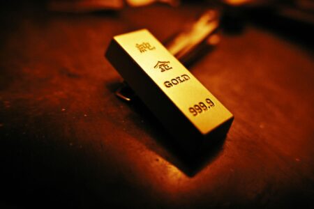 Stacked gold bars representing rising gold prices amid geopolitical uncertainty