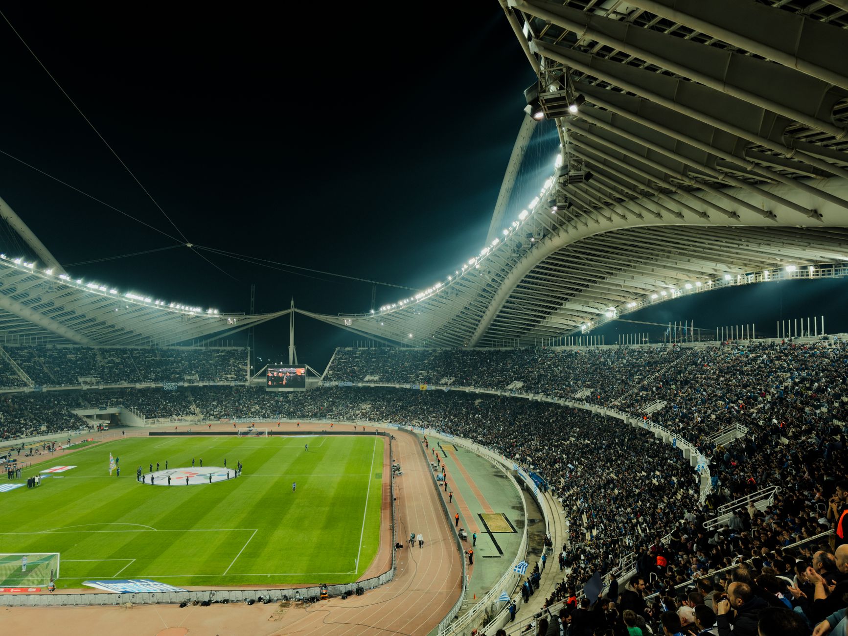 Crowded sports stadium during a live event under bright lights