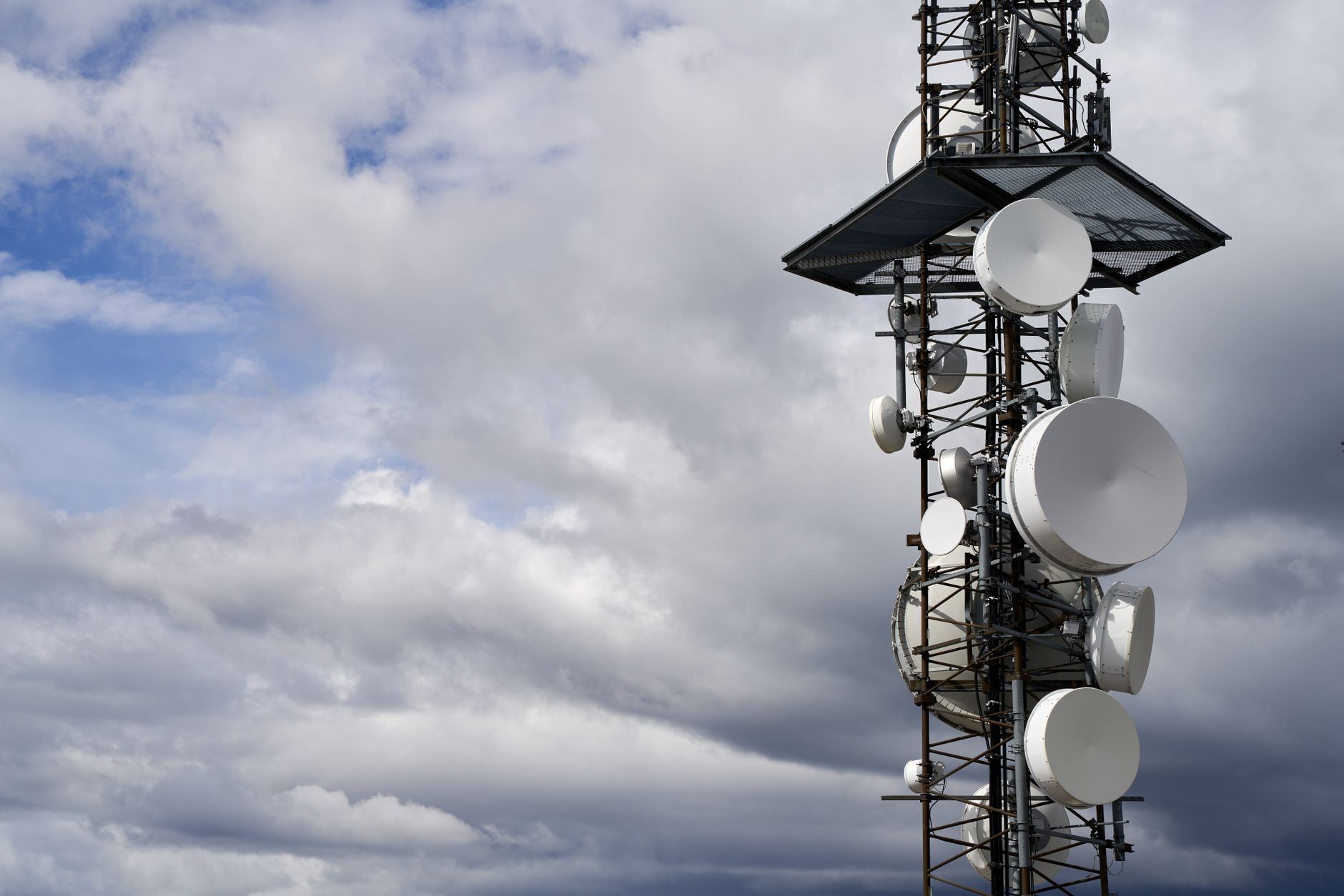 Cell tower against blue sky representing mobile carrier infrastructure