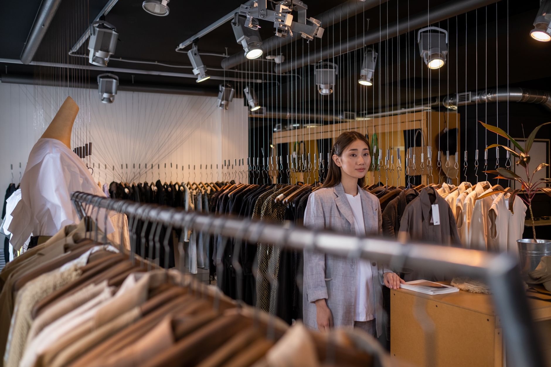 Shoppers browsing clothing in a large fashion retail store
