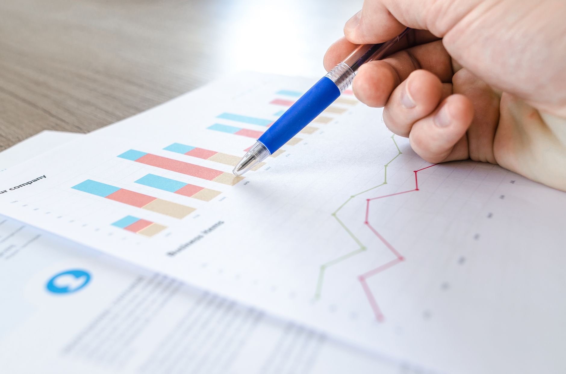 Investor reviewing financial data and investment charts at a desk