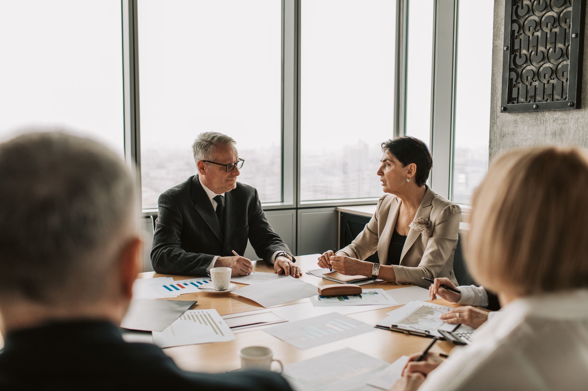 Executives in a boardroom discussing quarterly performance results and targets