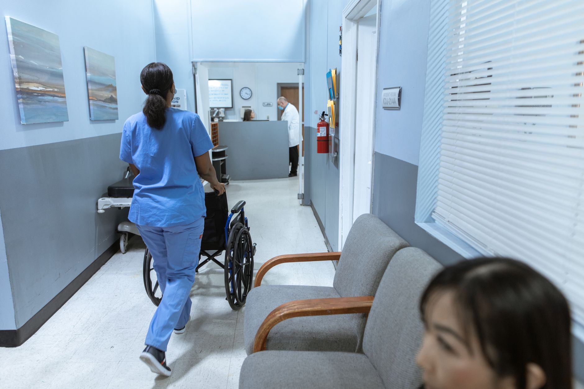 Empty hospital corridor with overhead lighting suggesting a medical facility