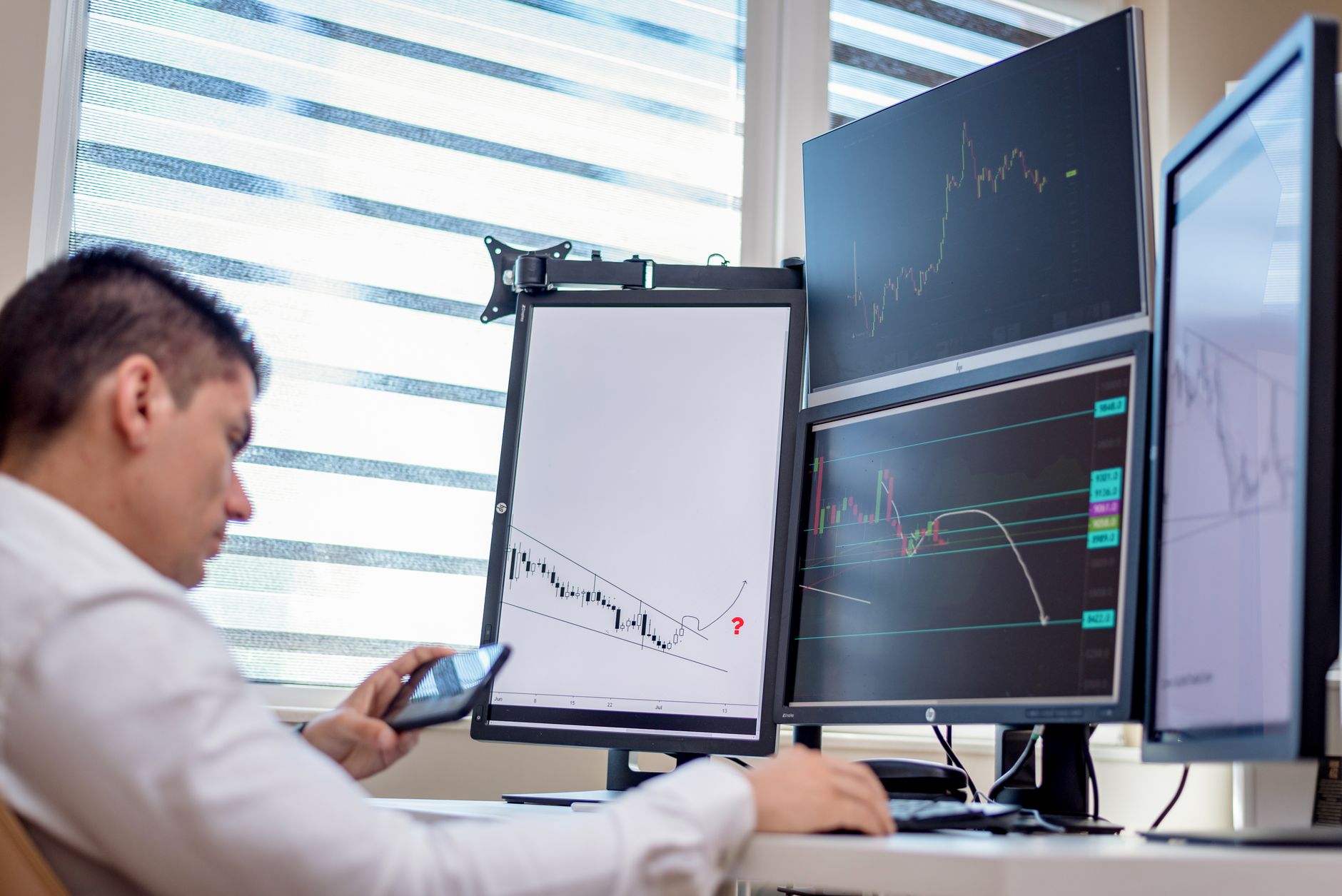 Trader watching financial monitors during a volatile pre-market session