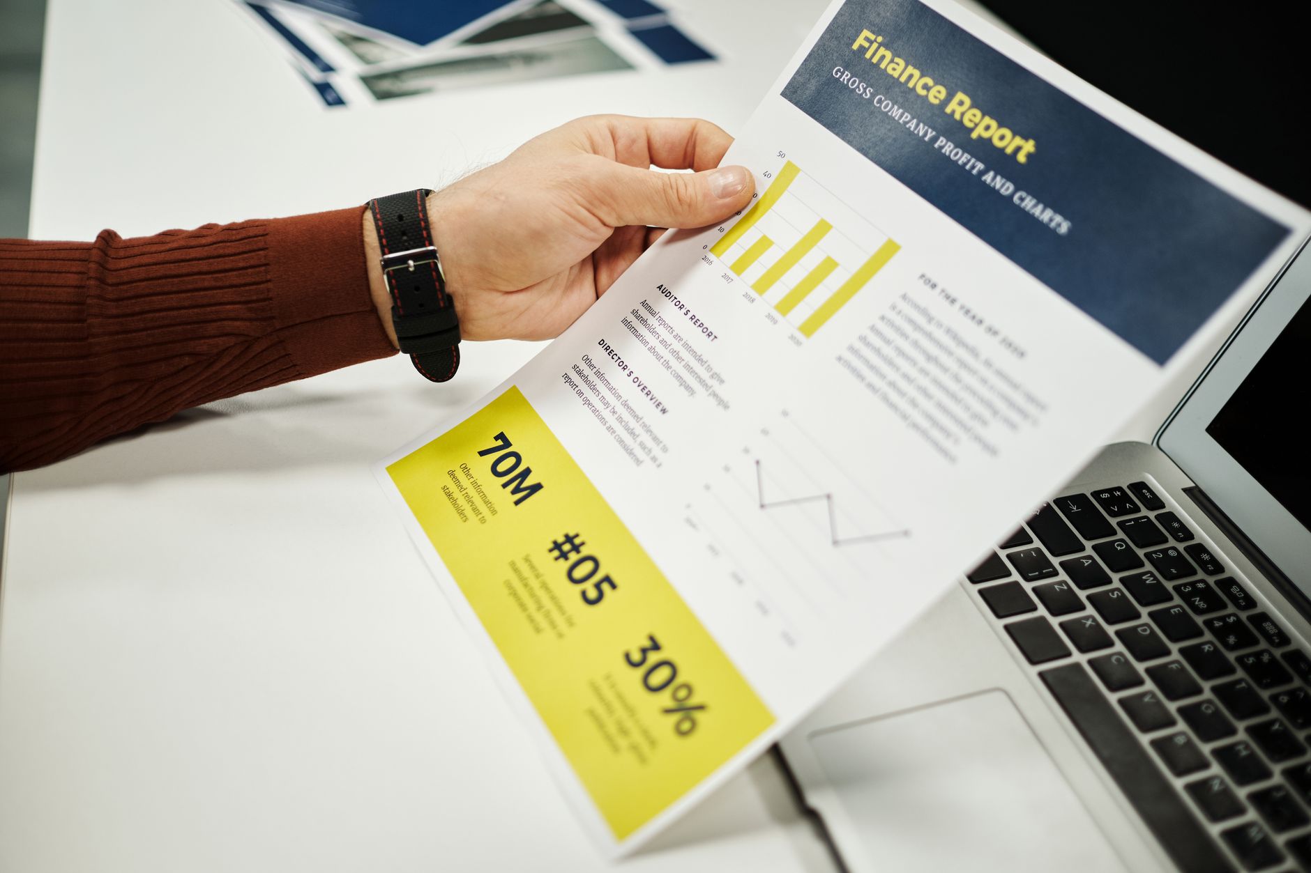 Financial analyst reviewing corporate earnings data on a laptop