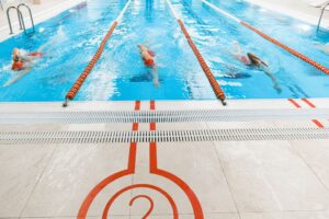 Phelps Family Name Enters Next Generation of Competitive Swimming Empty competitive swimming pool with lane dividers viewed from above