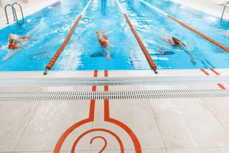Phelps Family Name Enters Next Generation of Competitive Swimming Empty competitive swimming pool with lane dividers viewed from above