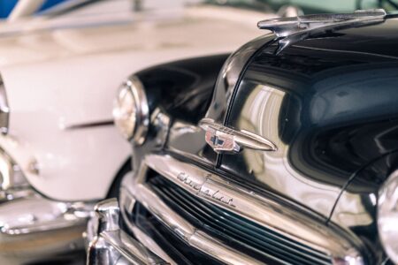 A restored classic American muscle car parked on an open road