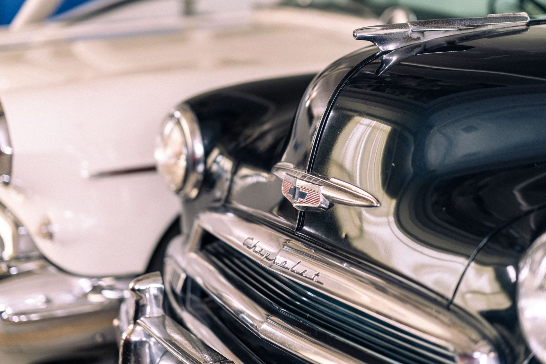 A restored classic American muscle car parked on an open road