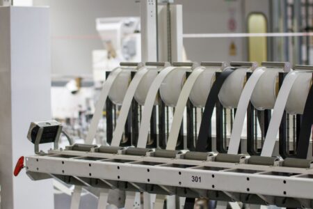 Workers on the floor of an aerospace manufacturing facility