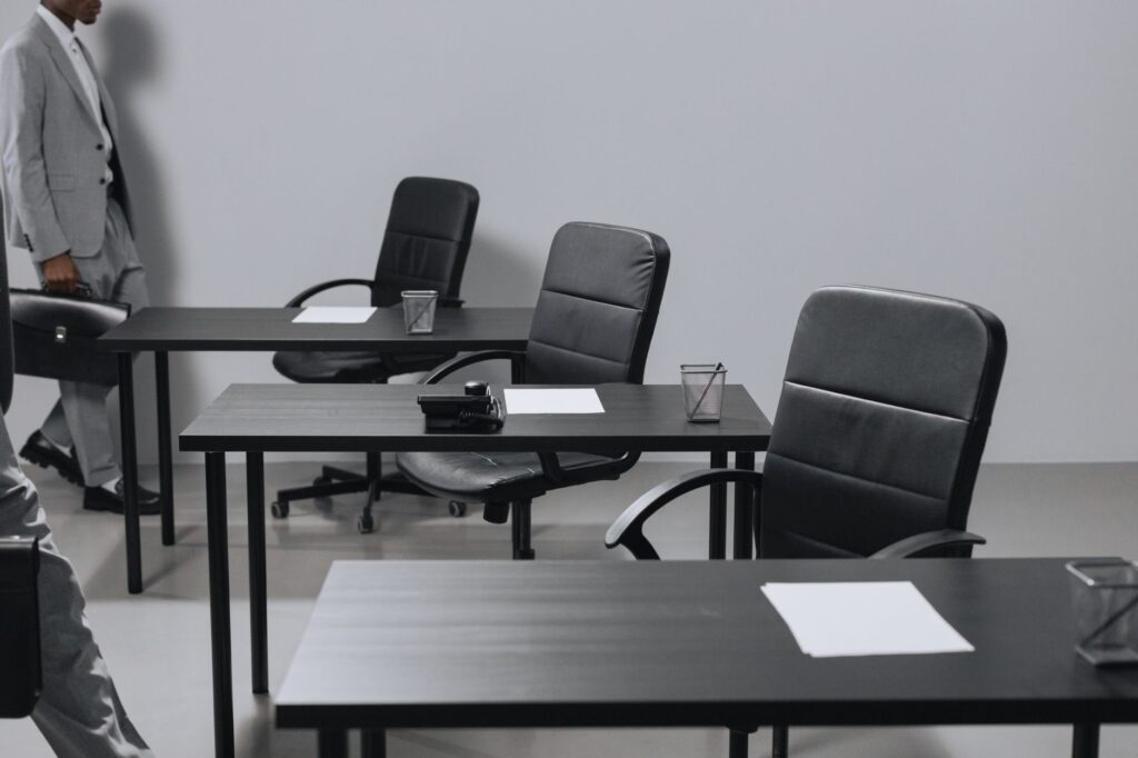 Empty office chairs representing slow hiring and job market weakness