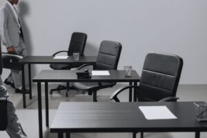 Empty office chairs representing slow hiring and job market weakness