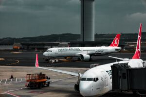 Wide view of a commercial aircraft assembly line inside a large manufacturing facility