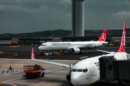 Wide view of a commercial aircraft assembly line inside a large manufacturing facility
