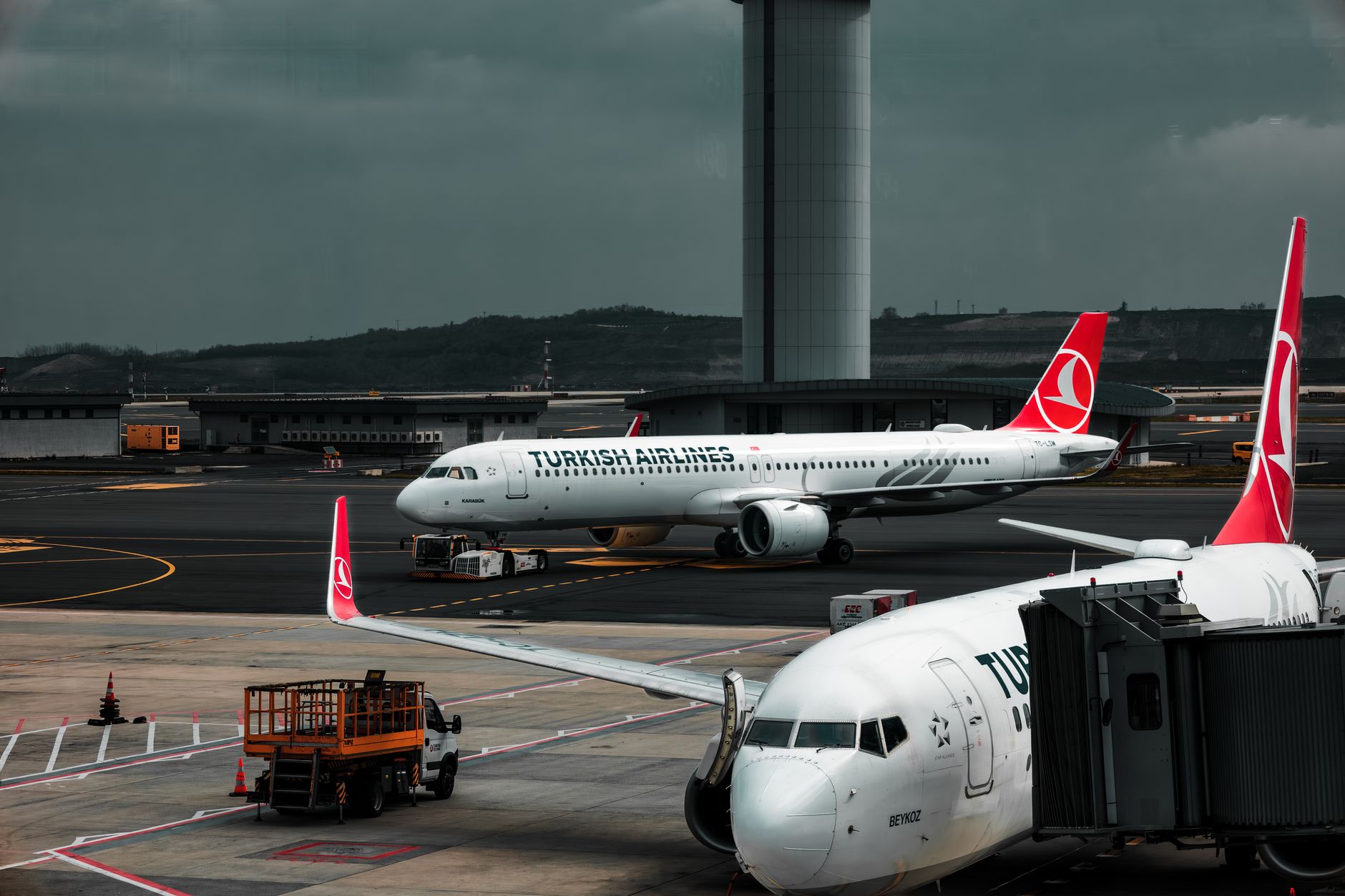 Wide view of a commercial aircraft assembly line inside a large manufacturing facility