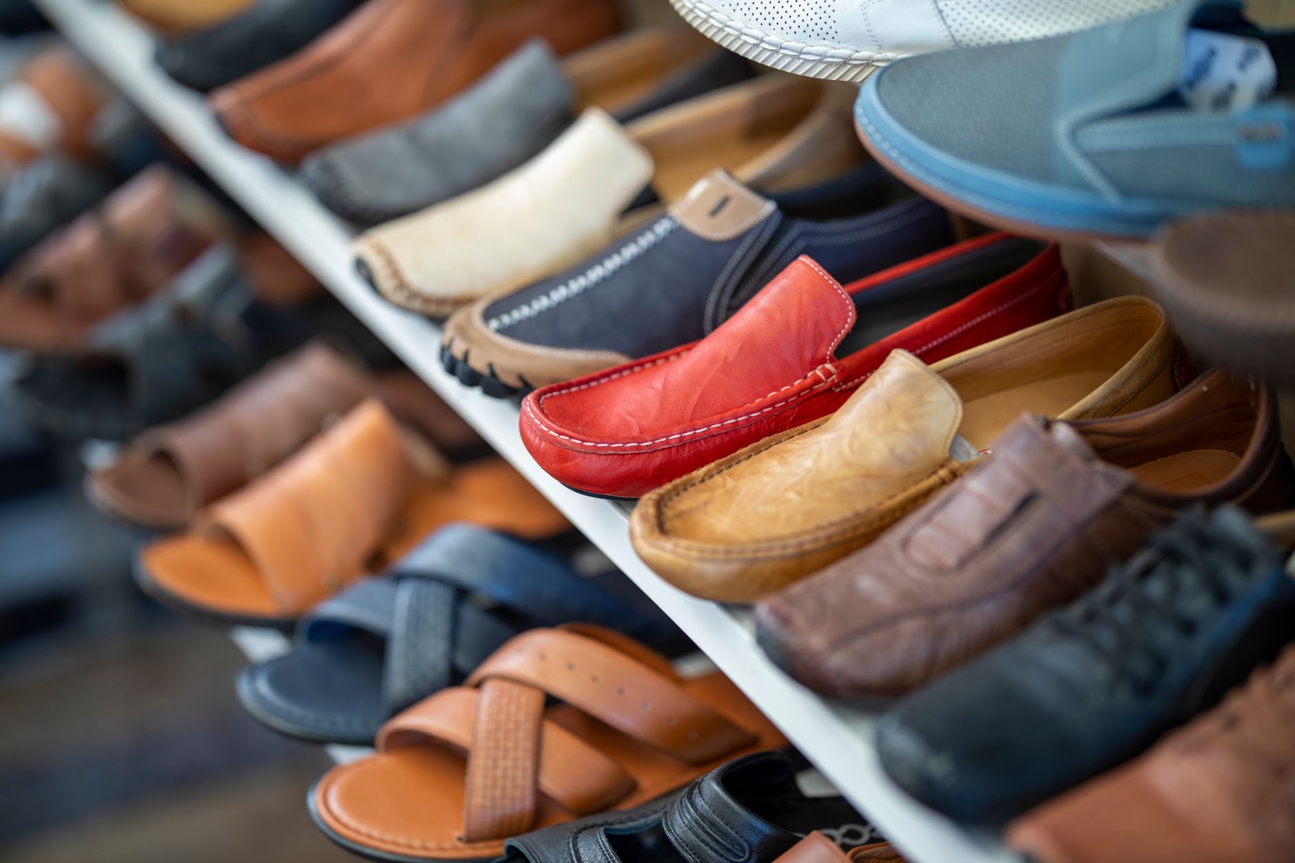 Affluent consumer browsing premium footwear in upscale store