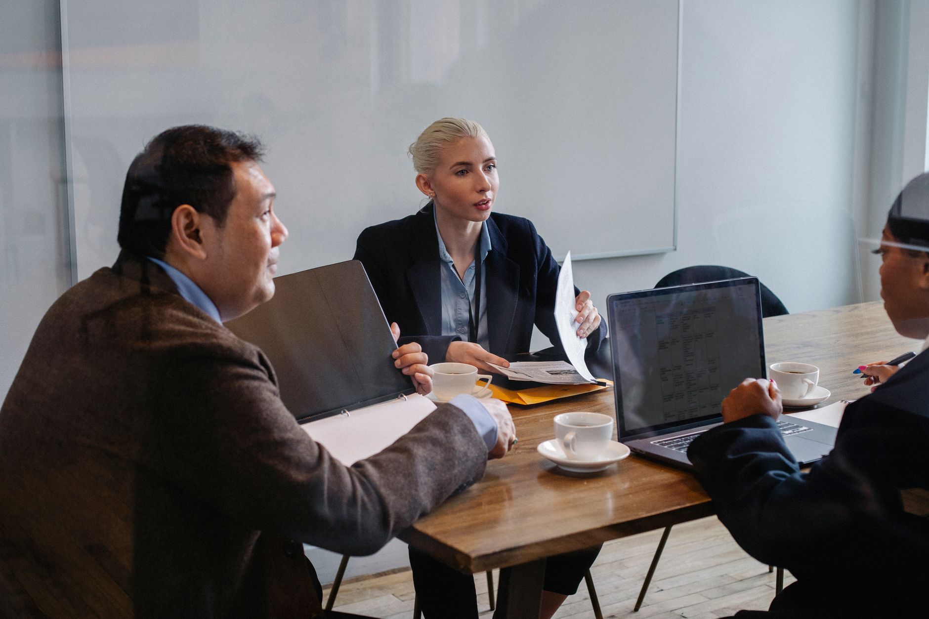 Business professionals reviewing financial projections on screens in a corporate setting