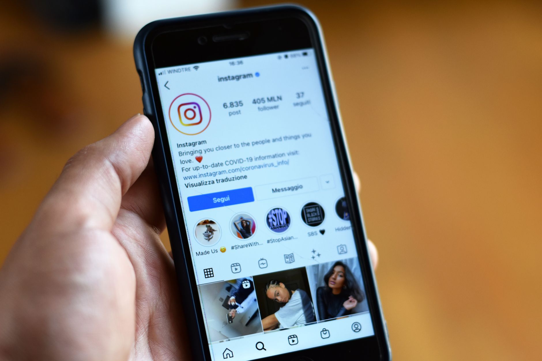 Person scrolling through a social media feed on a smartphone