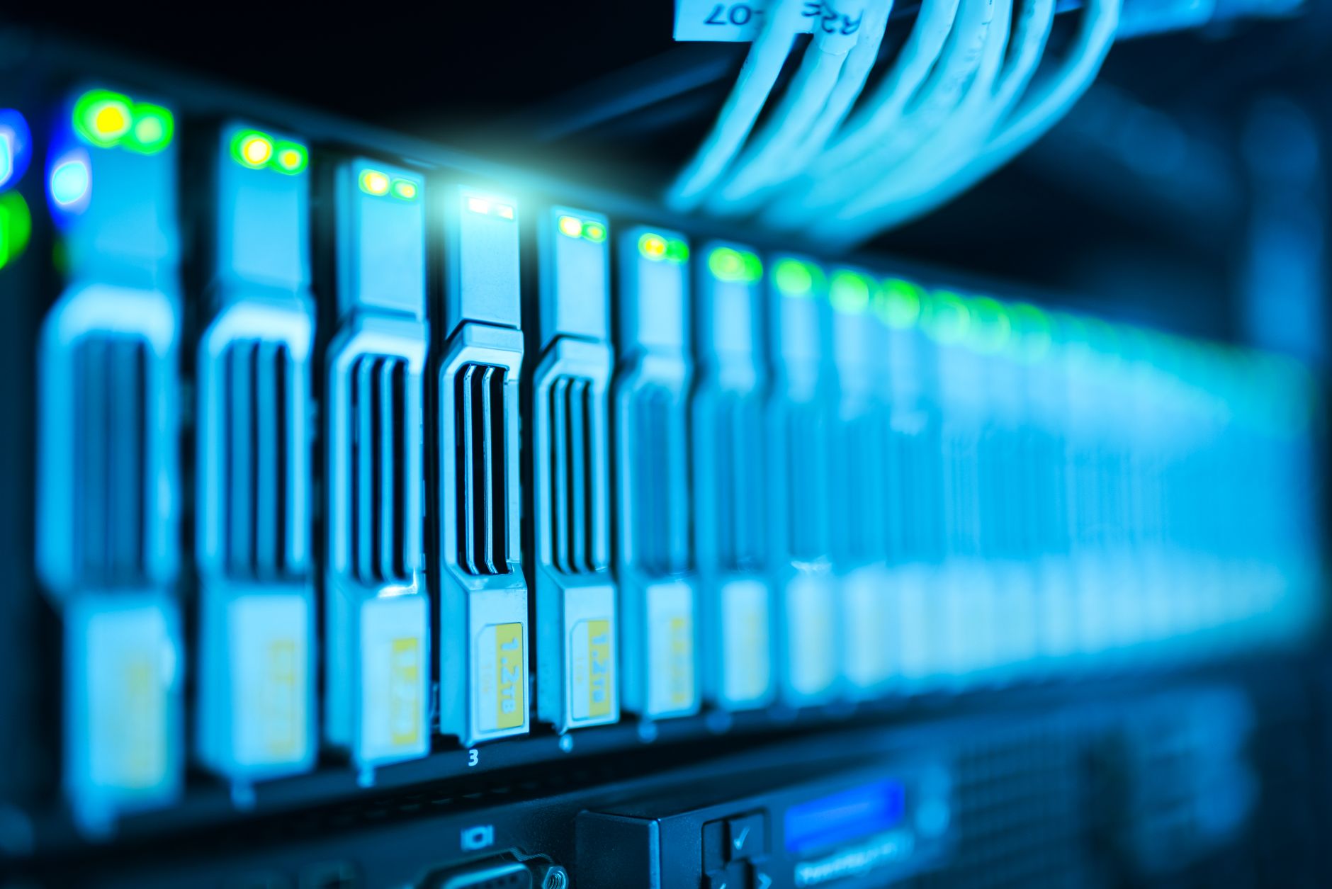Interior of a large data center facility with rows of servers and blue lighting