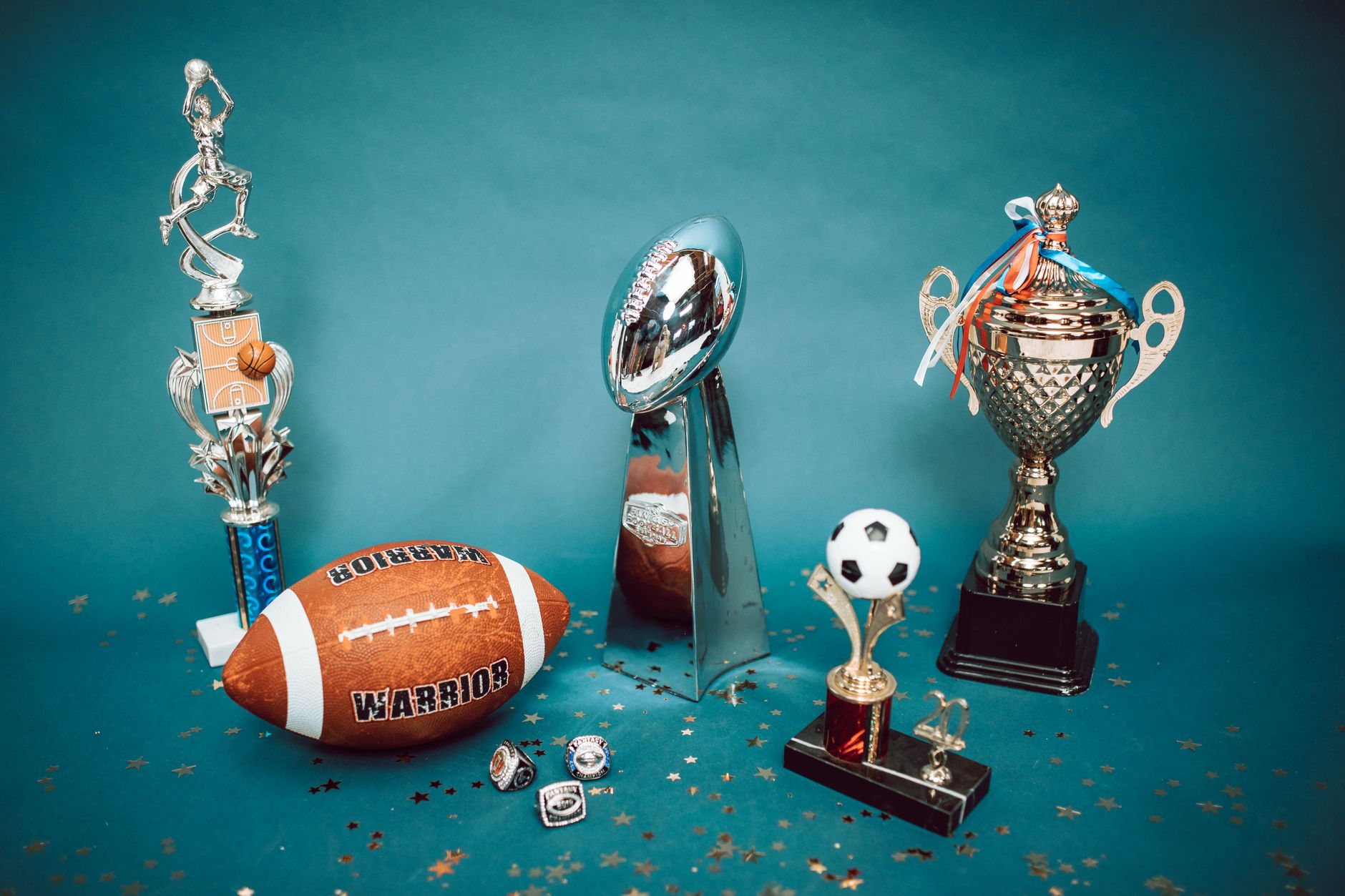 Glass trophy case inside a university athletic facility displaying championship hardware