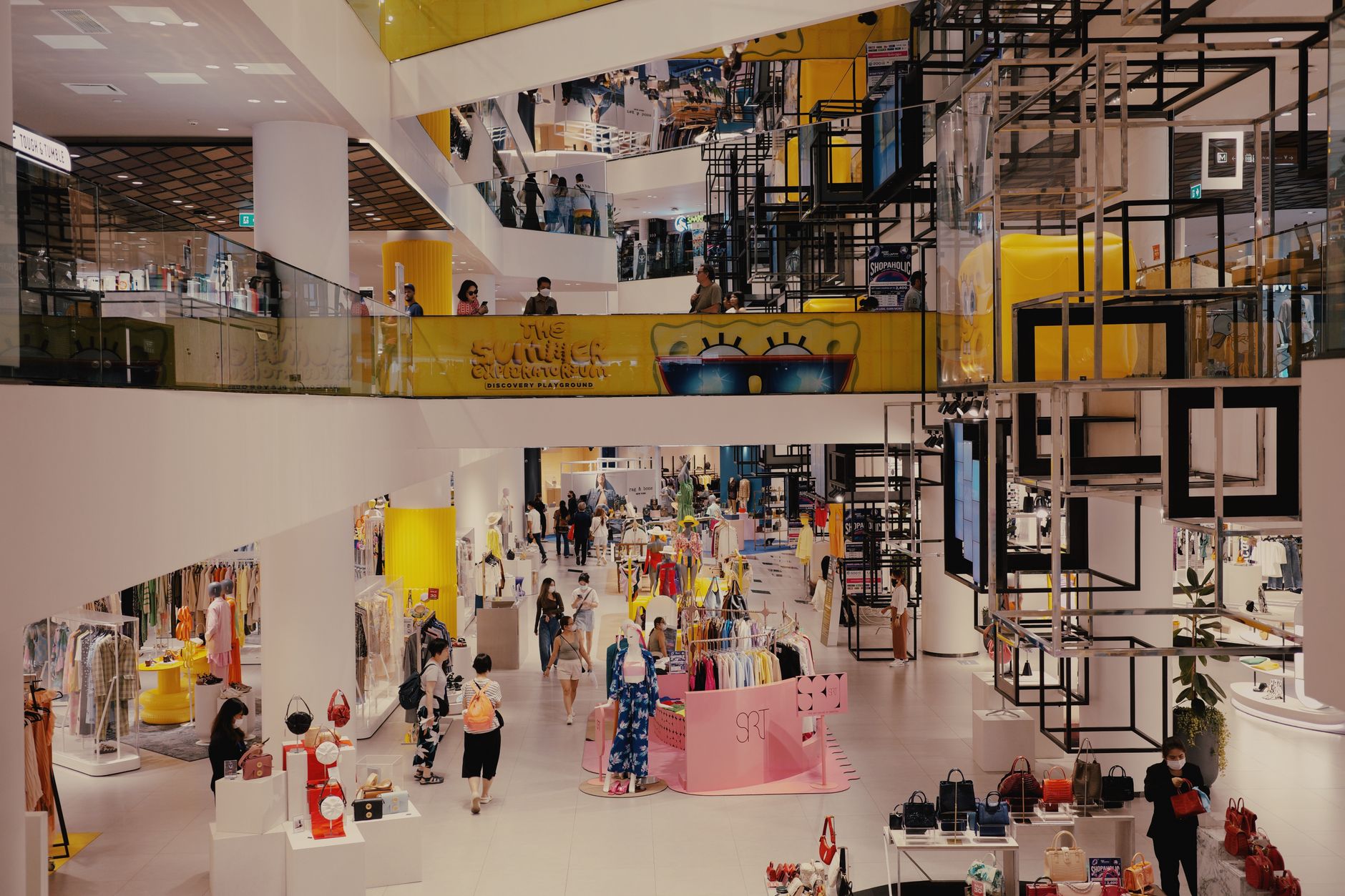 Wide interior shot of a modern retail store with product displays and shelving
