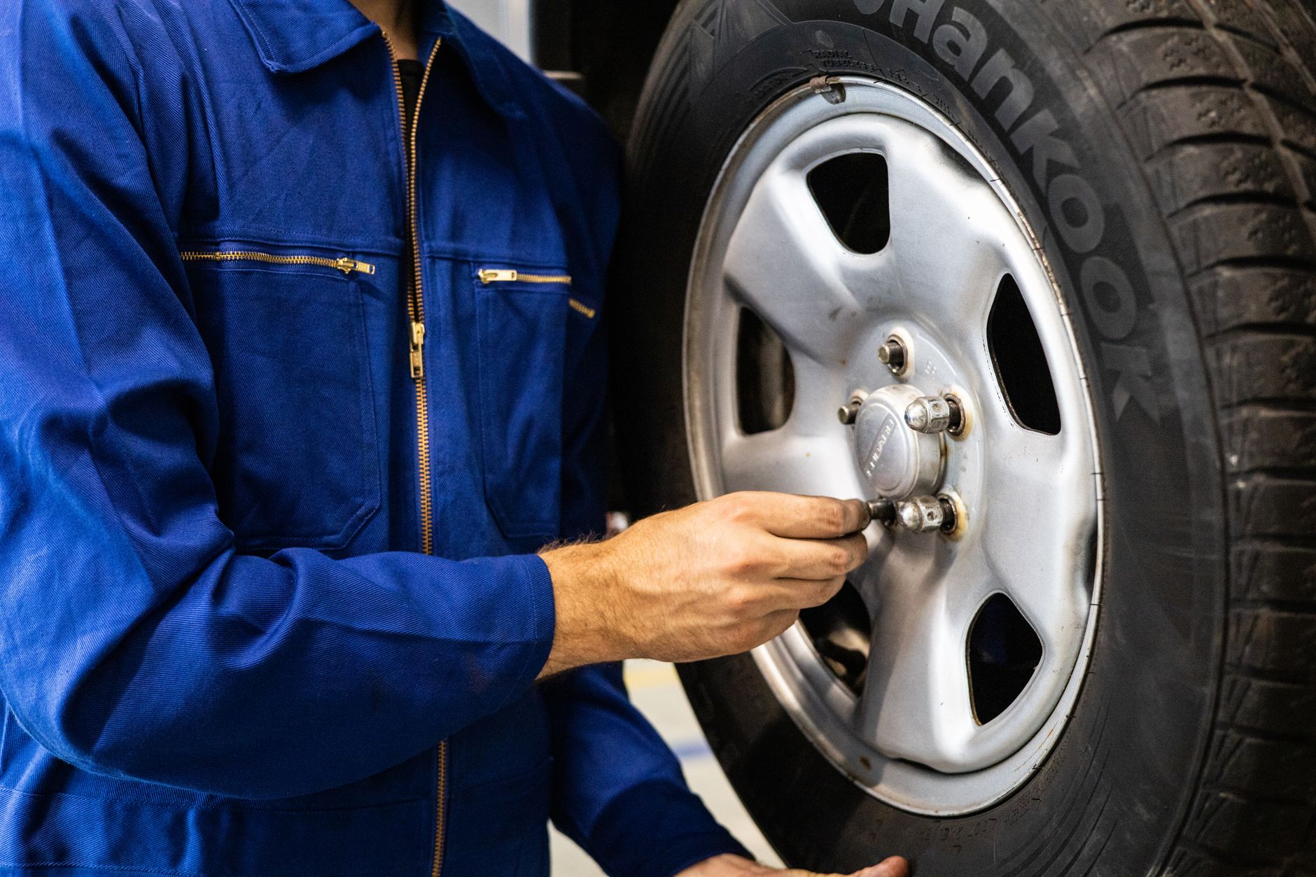 Technician performing a safety inspection on a vehicle