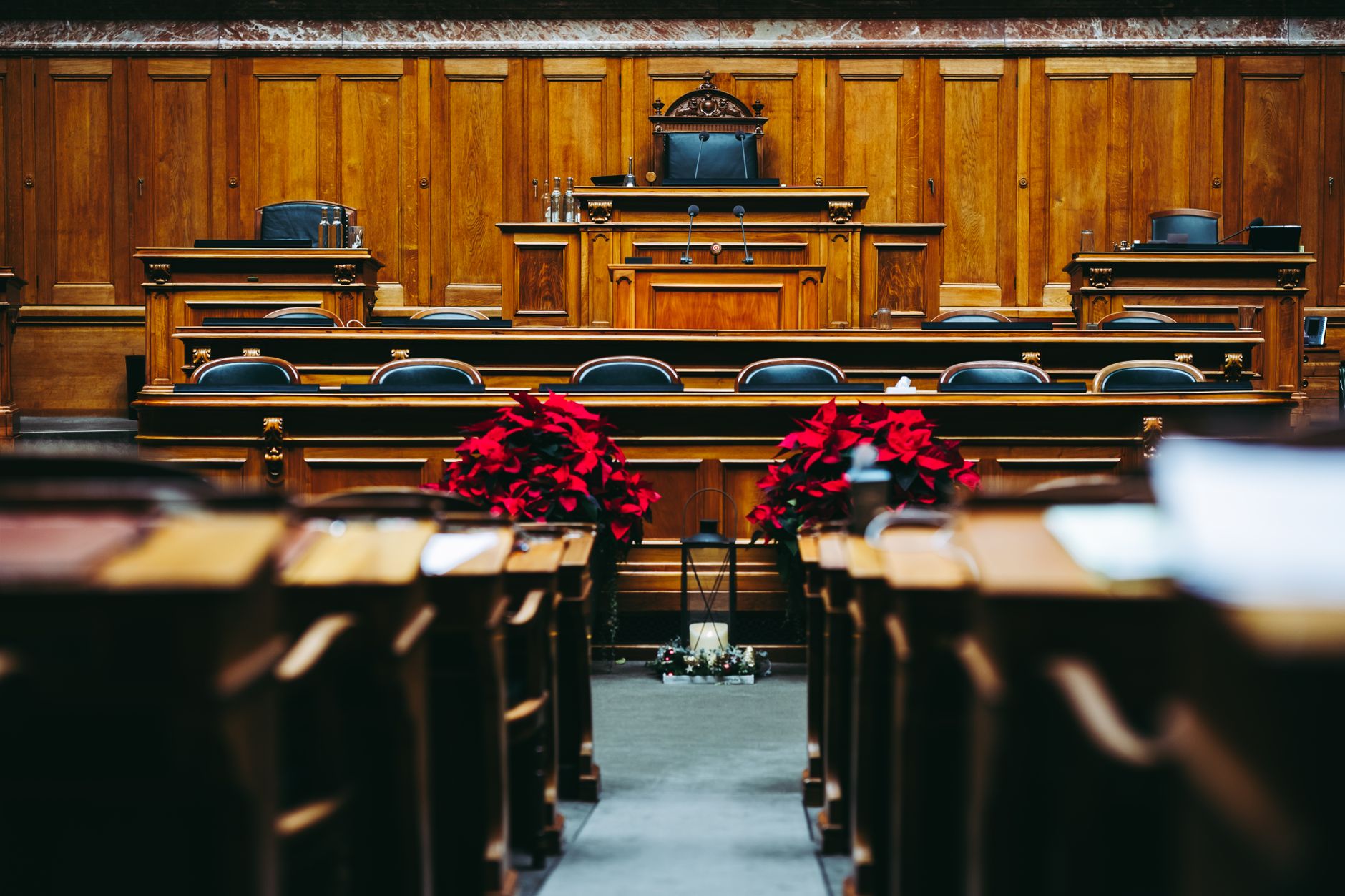 Empty courtroom with wooden benches and judge's bench