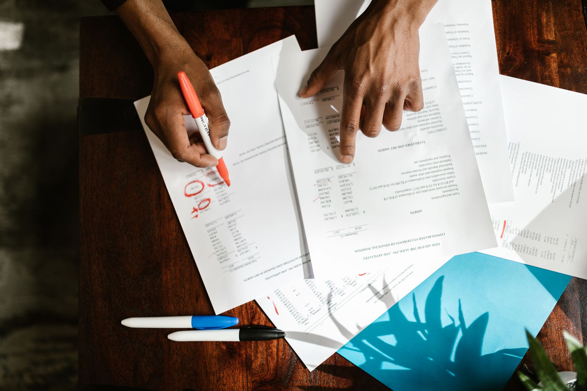 Financial documents and paperwork spread across an office desk
