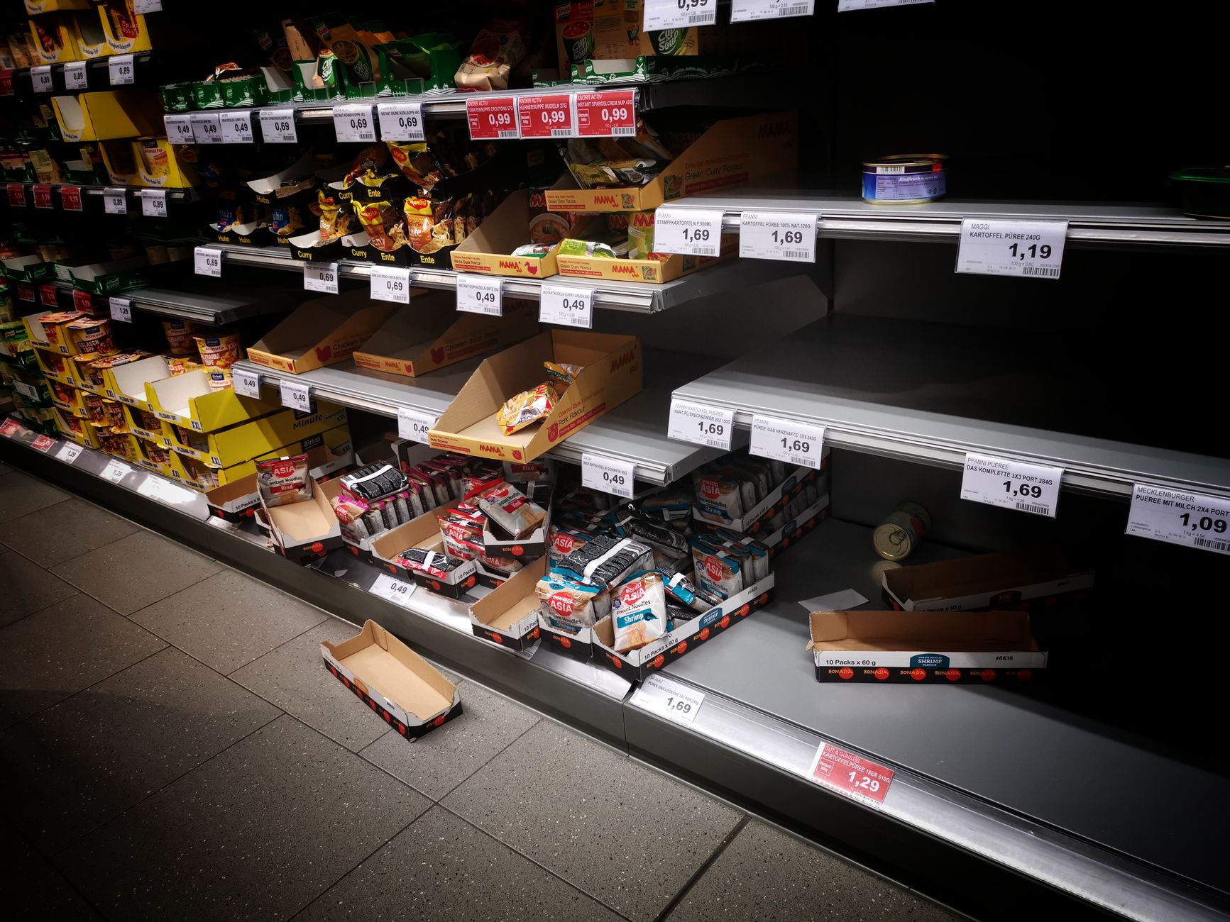 Nearly empty produce shelves at a grocery store during a food safety scare