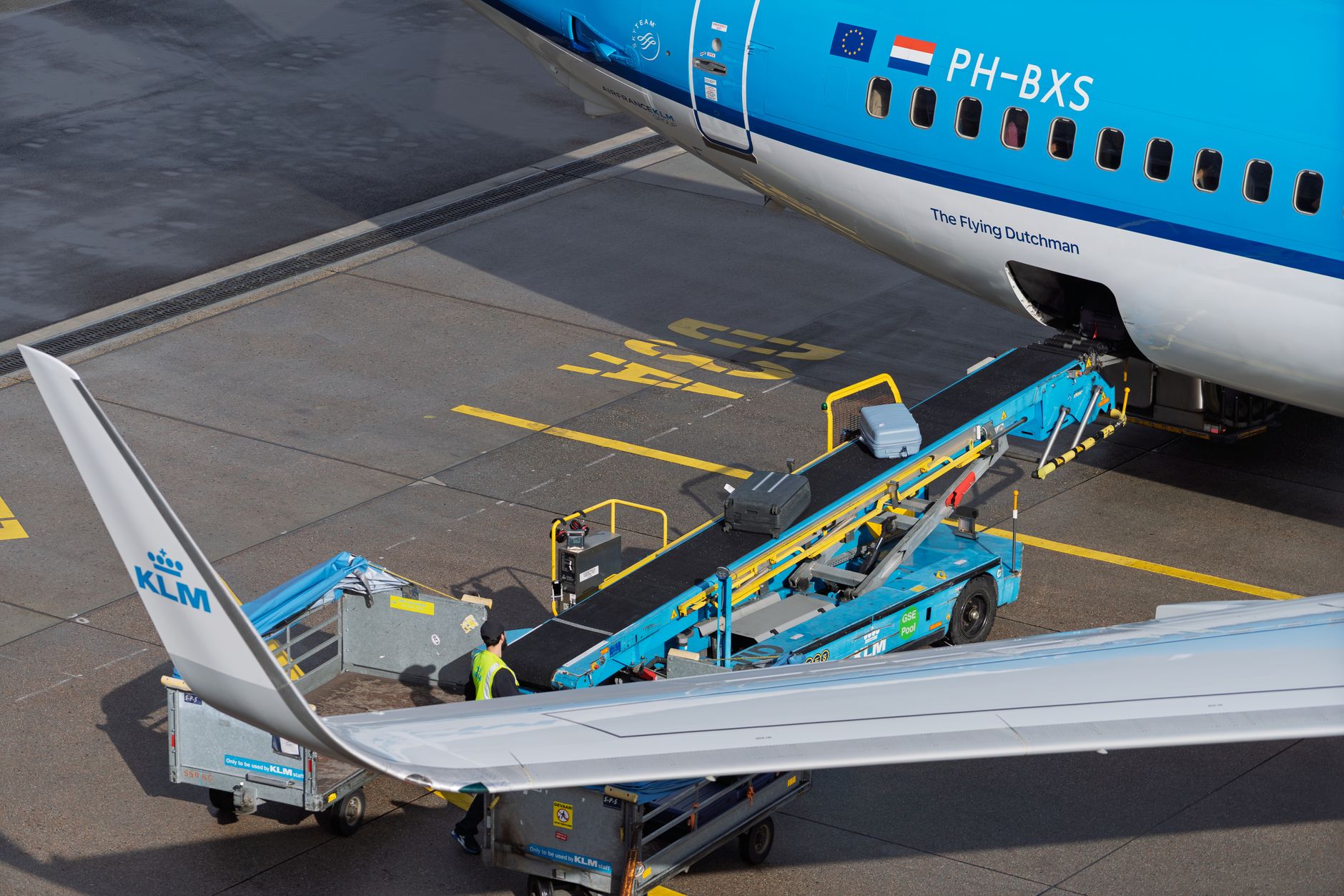 Aircraft being serviced by ground crew at a busy airport