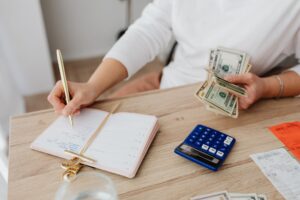 Young adult reviewing financial documents at a desk