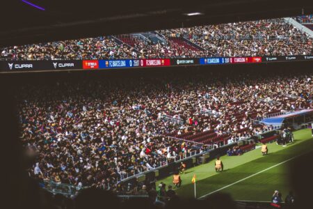 Packed NFL stadium with fans cheering during a night game