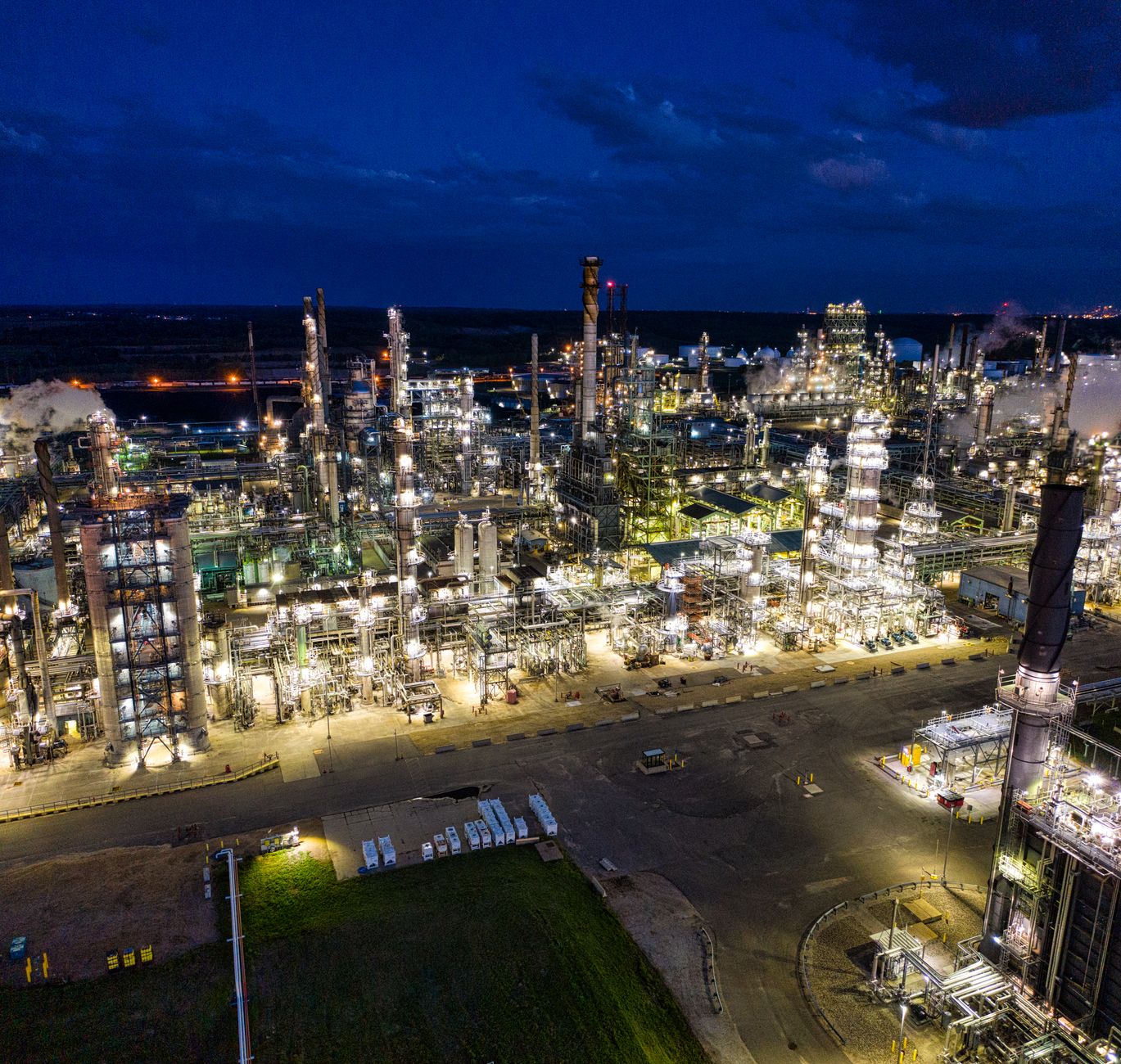 Industrial oil refinery with pipelines reflecting rising crude prices