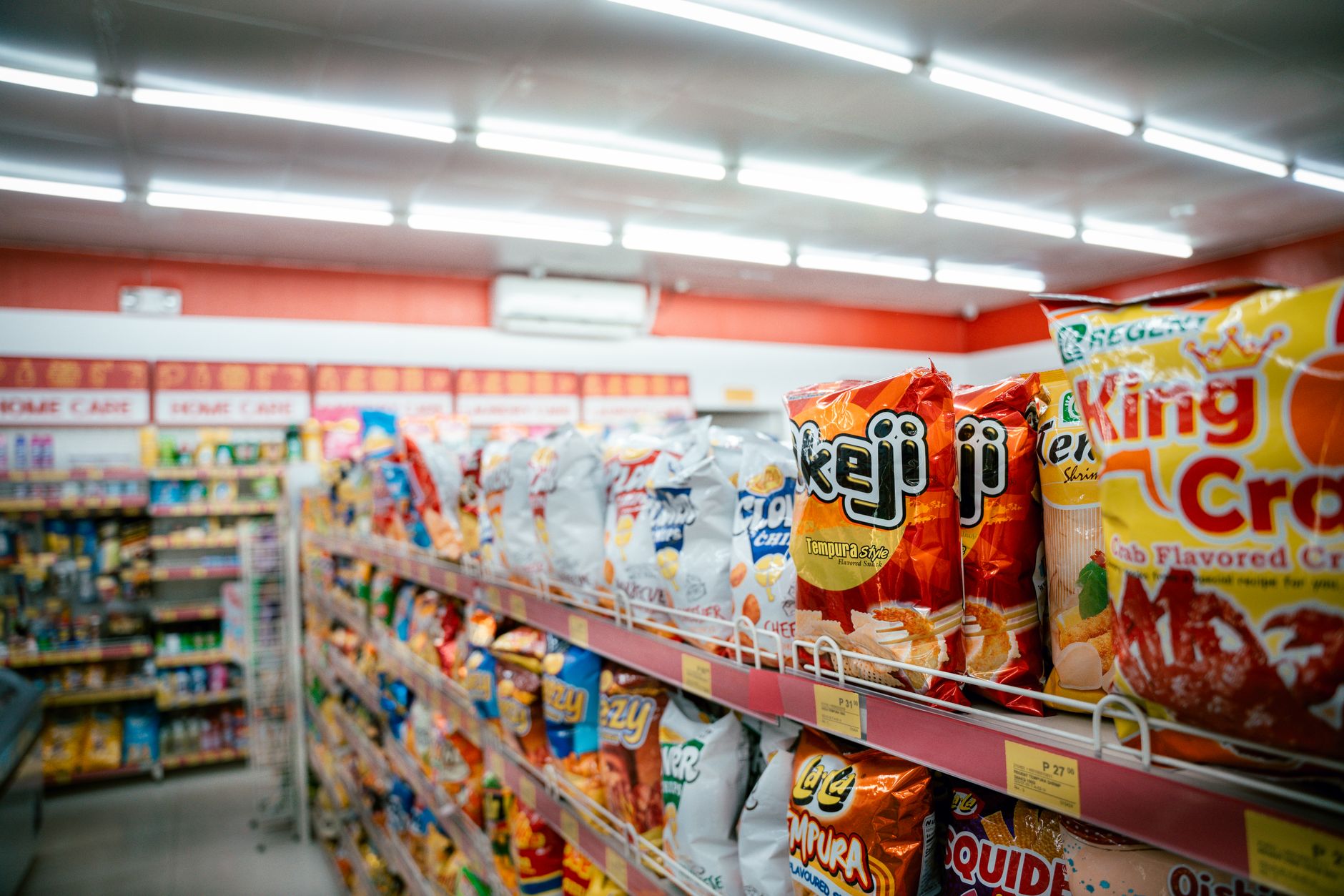 Grocery store aisle with product shelves showing consumer goods affected by rising transportation costs