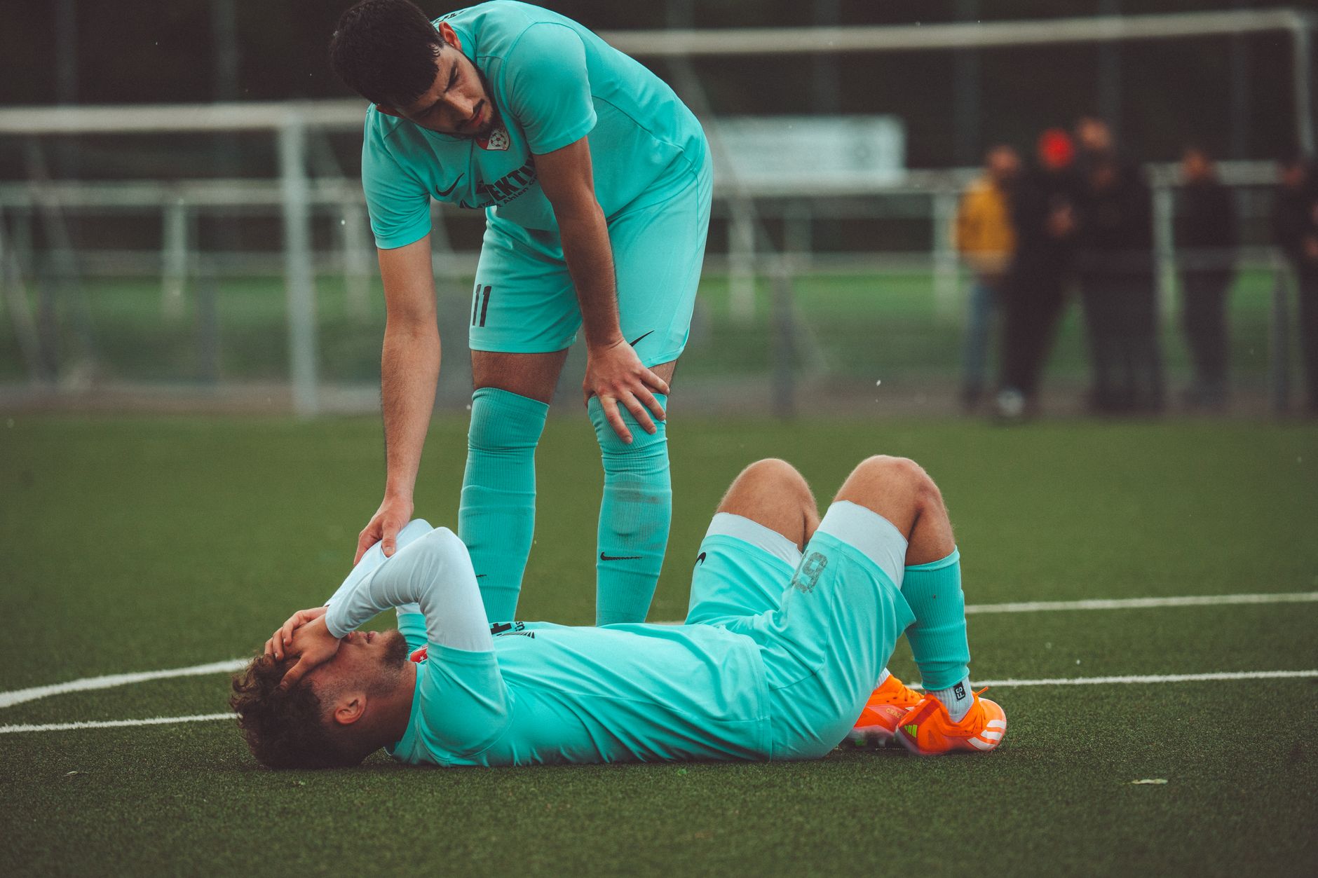 Medical staff attending to an athlete on a sports field
