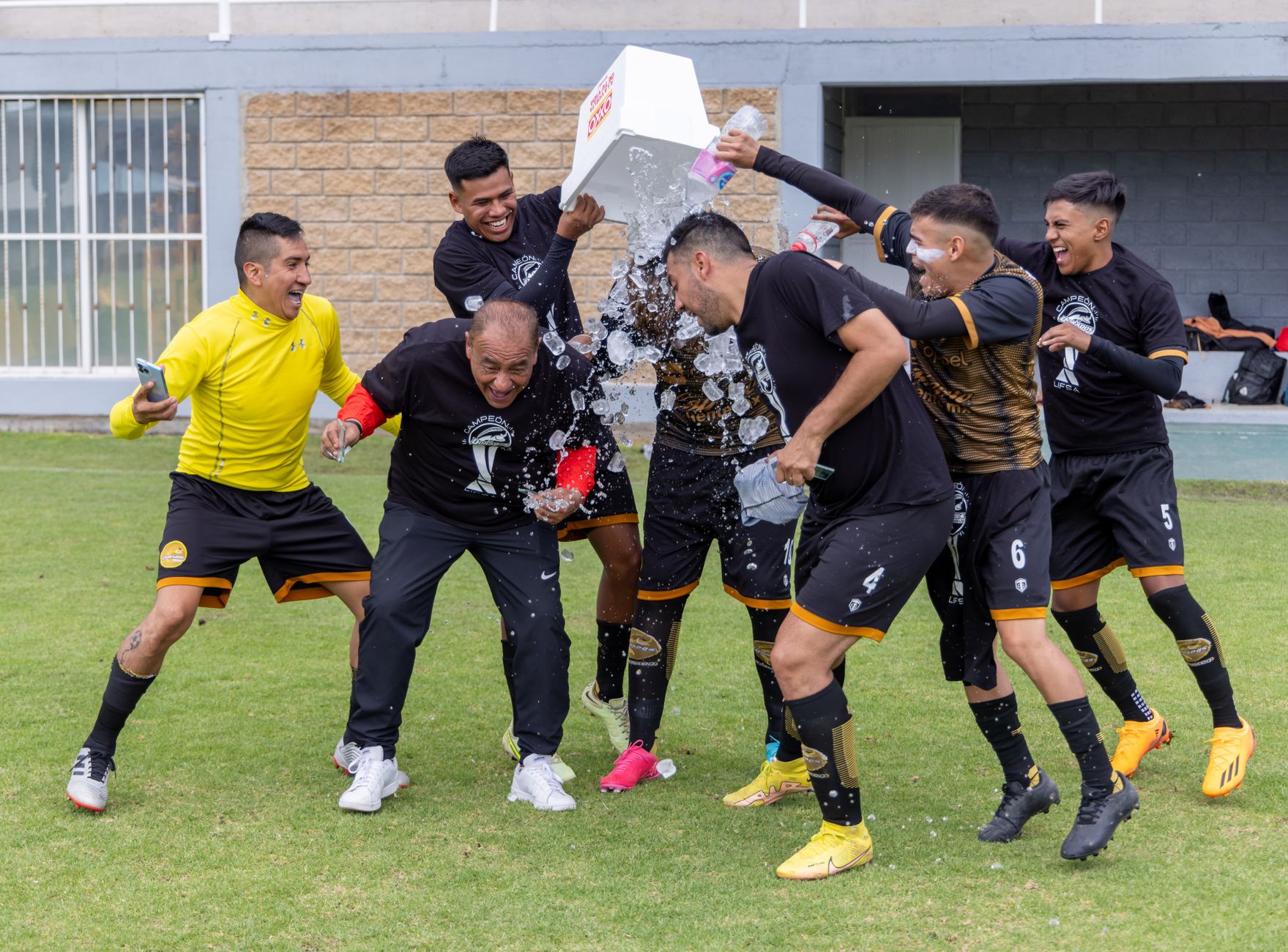 Football players celebrating a late-game victory on the field