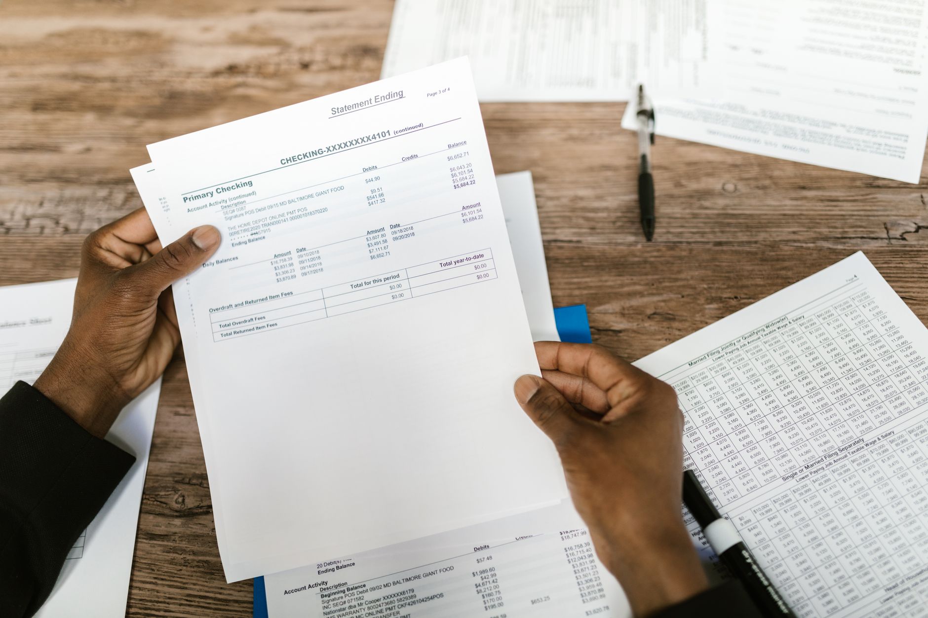 Person reviewing portfolio allocation documents at a desk