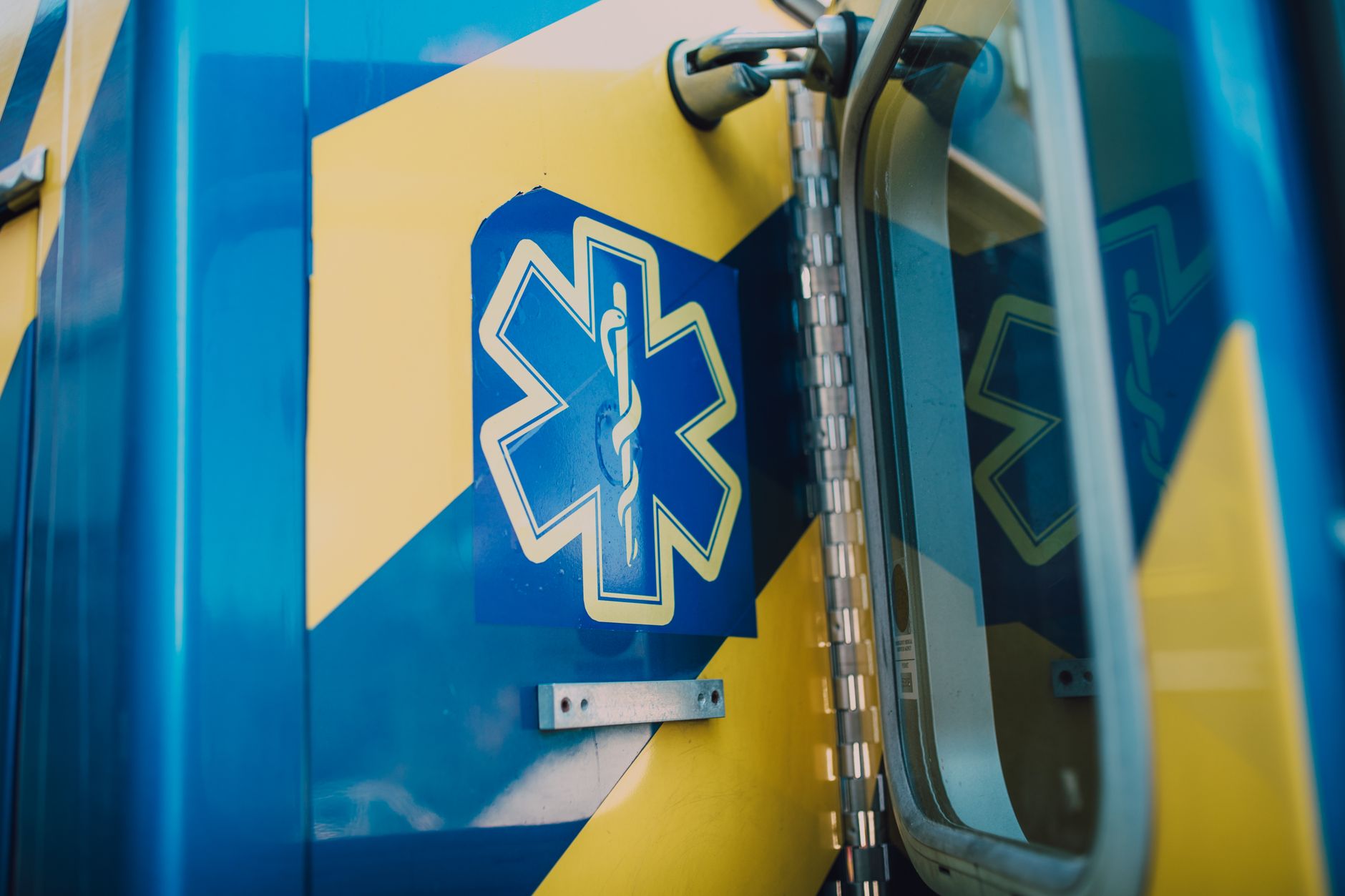 Emergency medical vehicle parked near an athletic venue entrance