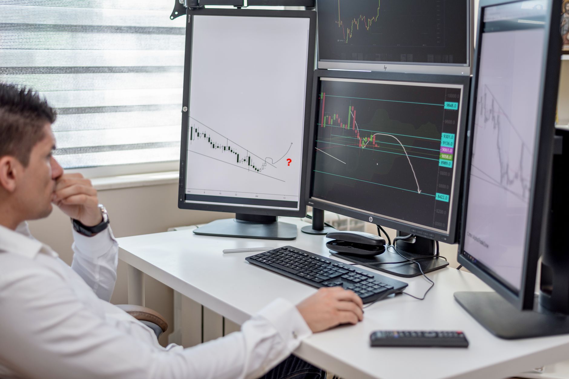 Financial analysts reviewing investment data on computer screens