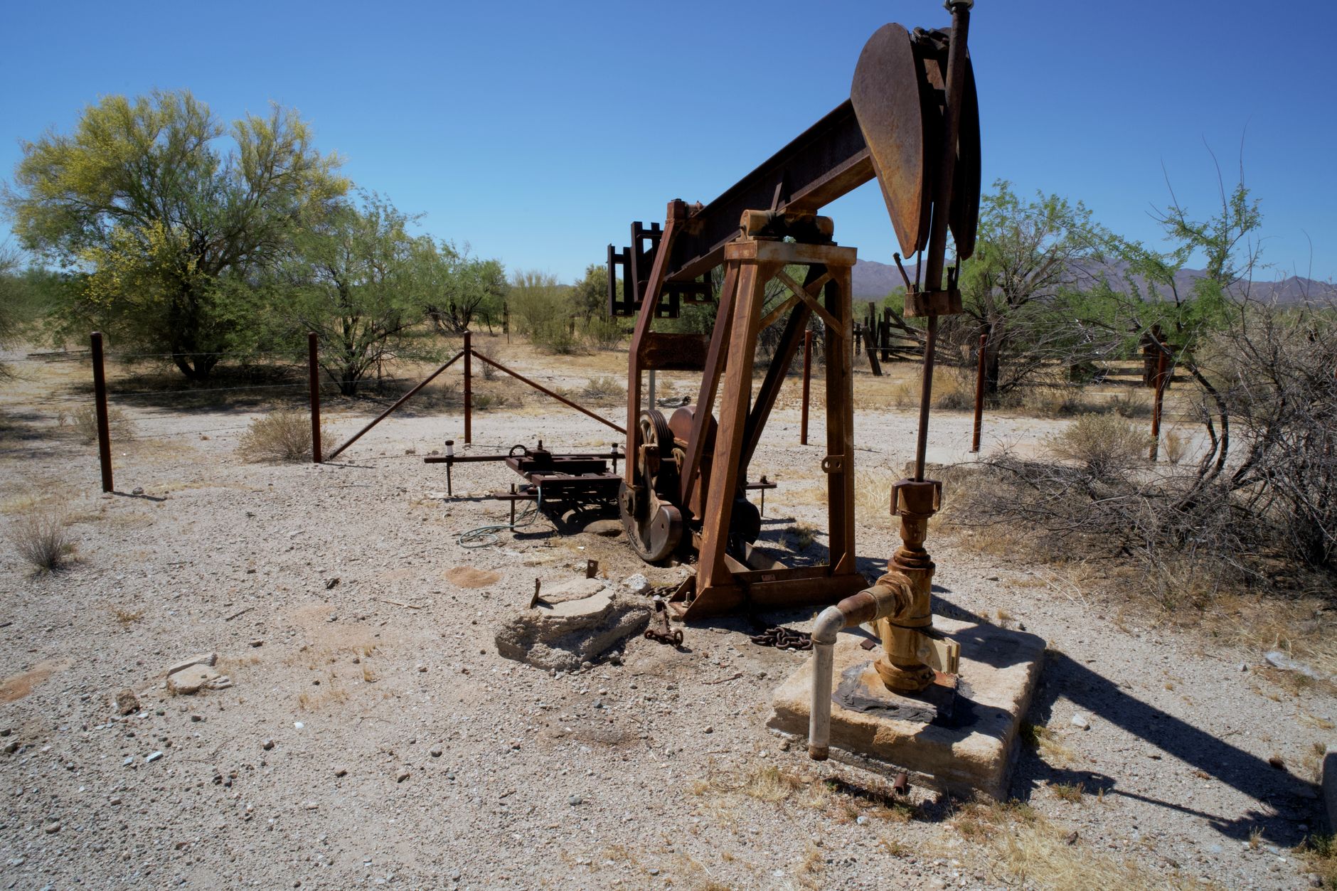 Large crude oil pipeline running across an open industrial landscape