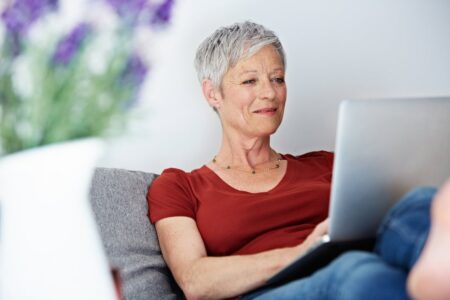 Elderly person reviewing financial documents and Social Security paperwork at a desk
