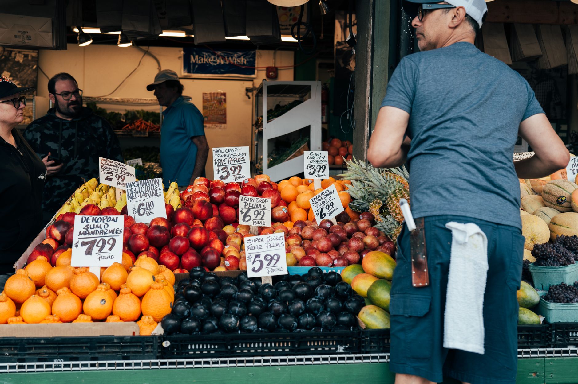 A shopper examining price tags in a grocery store aisle