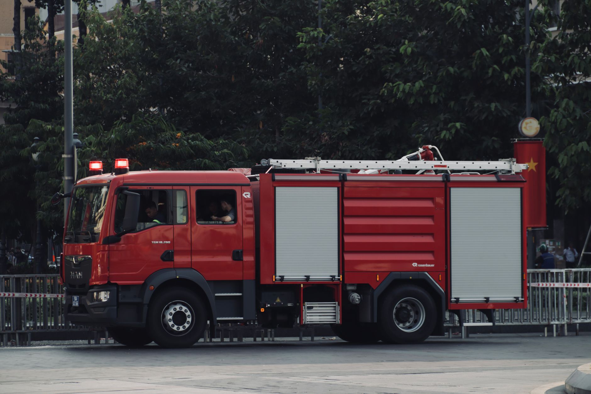 Fire department trucks responding to an industrial emergency call