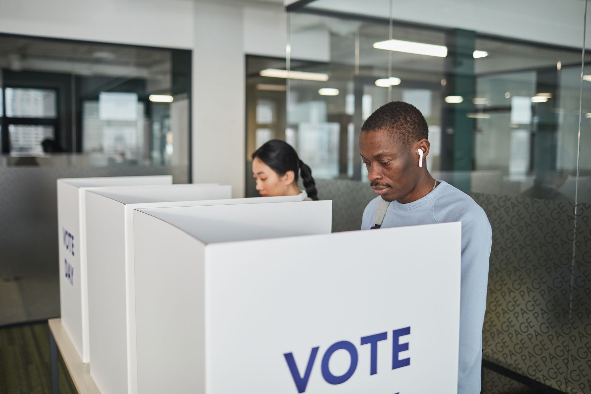 A voter standing at a voting booth during an election
