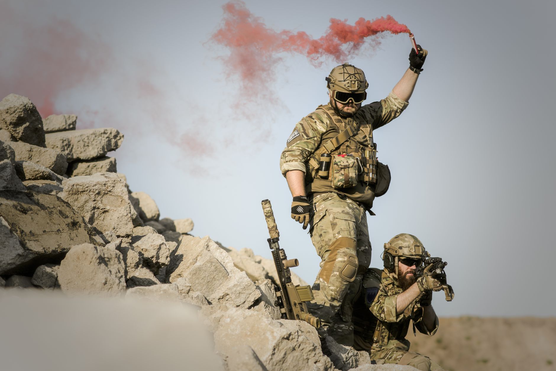 Soldiers moving through rugged terrain during a ground operation